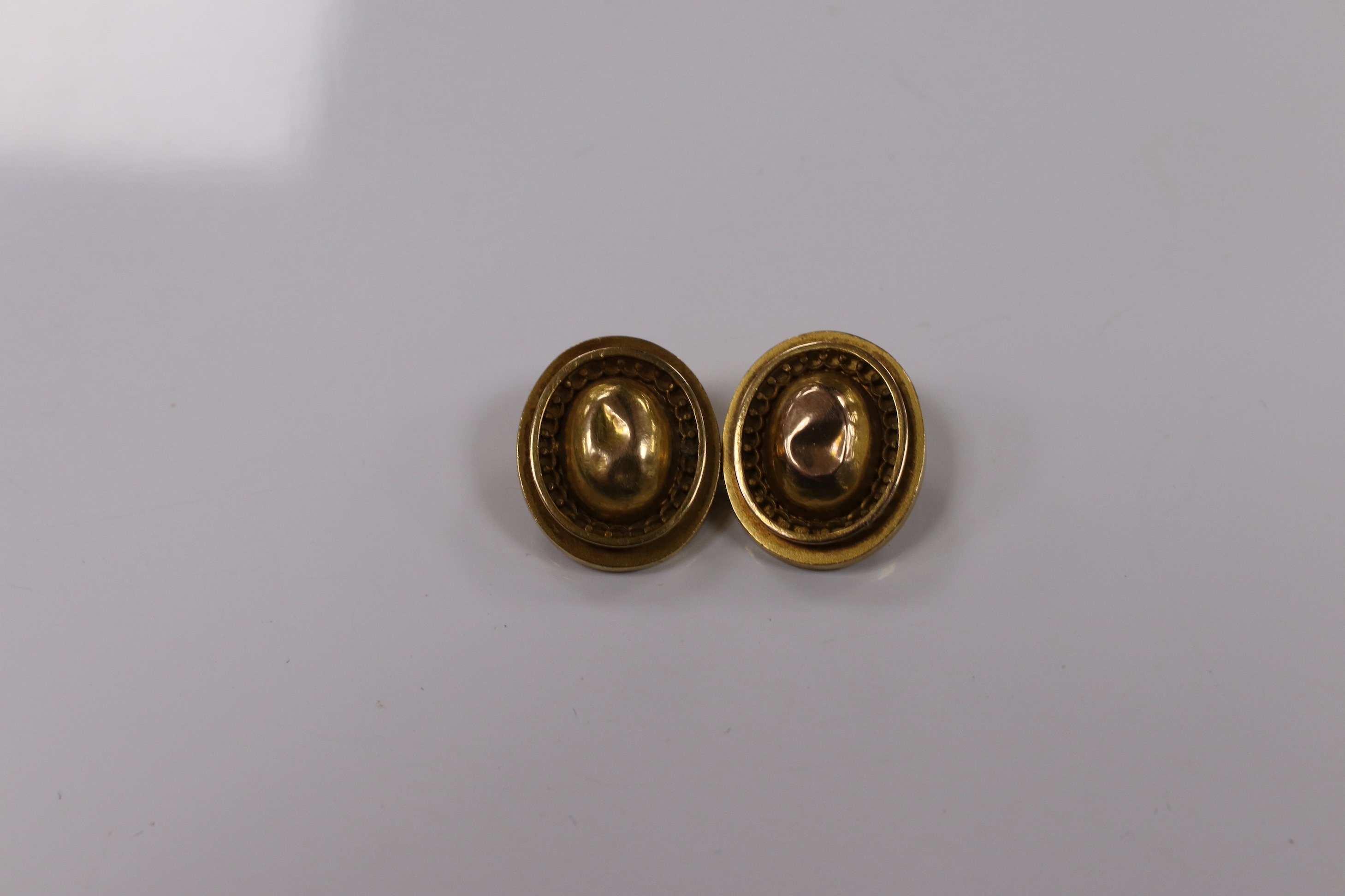 A pair of yellow metal oval cufflinks and three similar dress studs, one stamped 18, gross weight 10.8 grams. Condition - poor